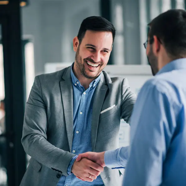 Businessmen sealing a bridging finance deal with a handshake